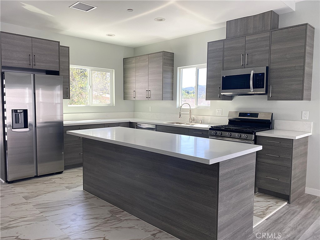 955 Brossard Drive Thousand Oaks, CA 91360 - Photo 4 of 19 a kitchen with granite countertop a sink stove and refrigerator