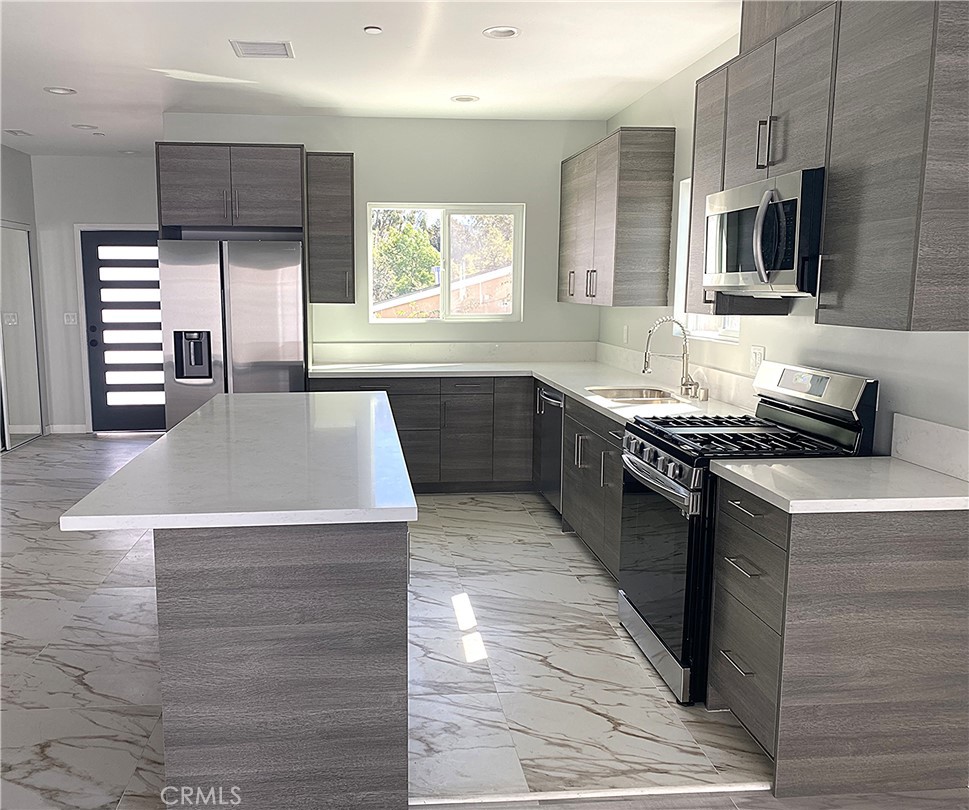 955 Brossard Drive Thousand Oaks, CA 91360 - Photo 5 of 19 a kitchen with stainless steel appliances granite countertop a sink and a stove