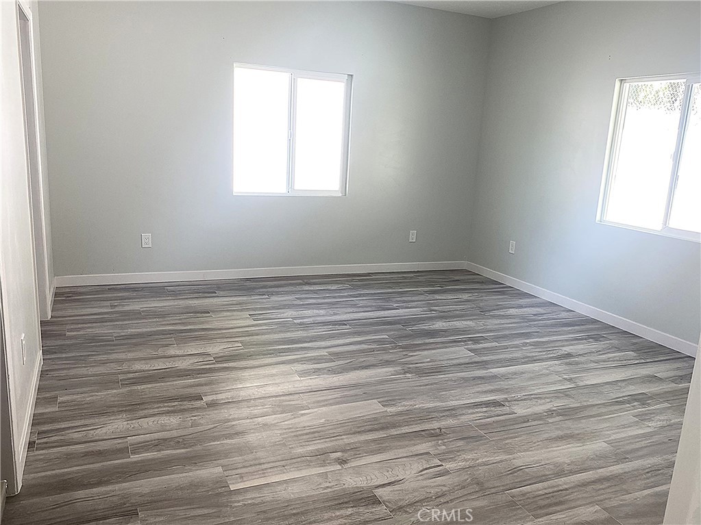 955 Brossard Drive Thousand Oaks, CA 91360 - Photo 6 of 19 an empty room with wooden floor and windows
