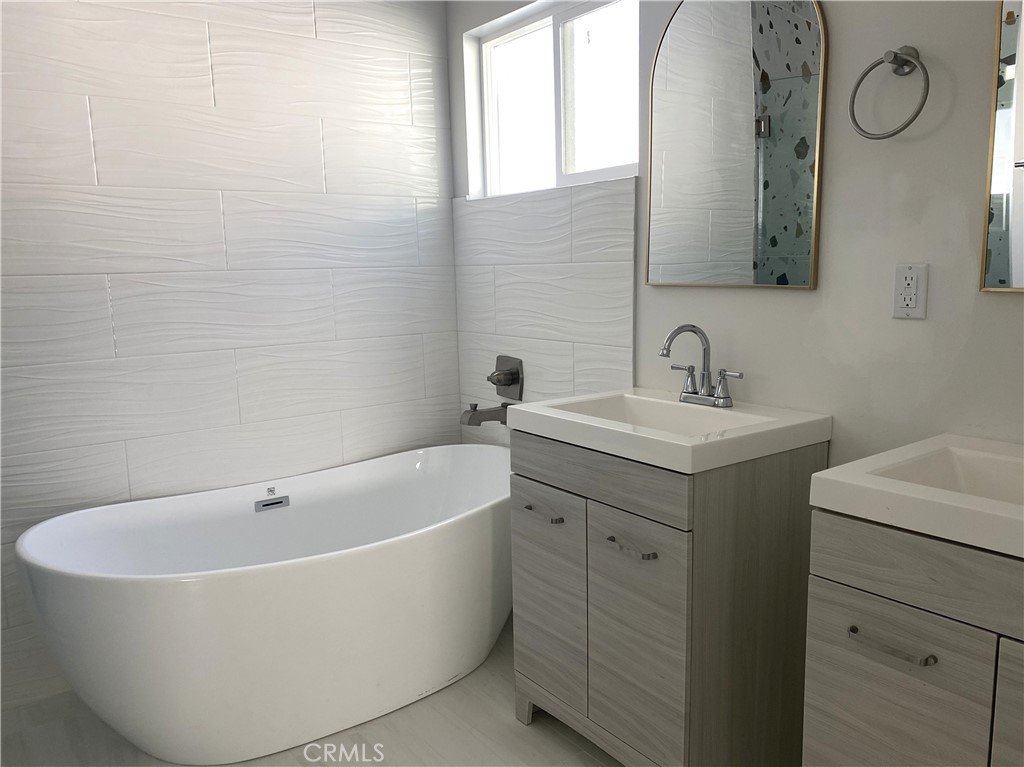 955 Brossard Drive Thousand Oaks, CA 91360 - Photo 8 of 19 a white bath tub sitting next to a bathroom sink