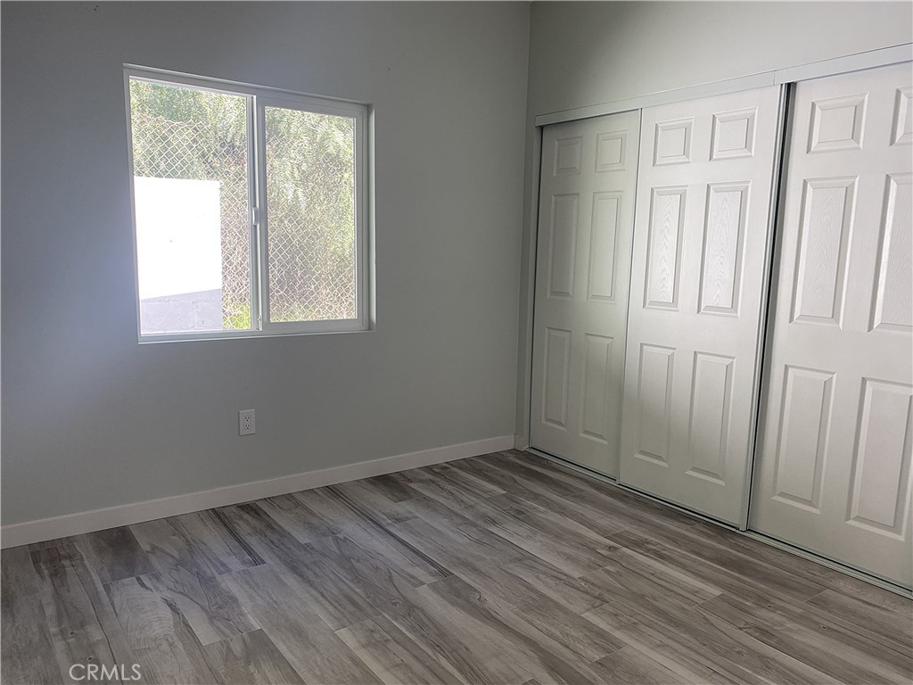 955 Brossard Drive Thousand Oaks, CA 91360 - Photo 10 of 19 an empty room with wooden floor and windows