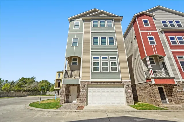 a front view of a residential apartment building with a yard