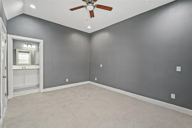 an empty room with a window and a ceiling fan