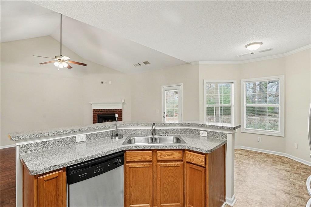 1558 Kilgore Road Griffin, GA 30223 - Photo 13 of 32 a kitchen with stainless steel appliances granite countertop a sink and a granite counter tops