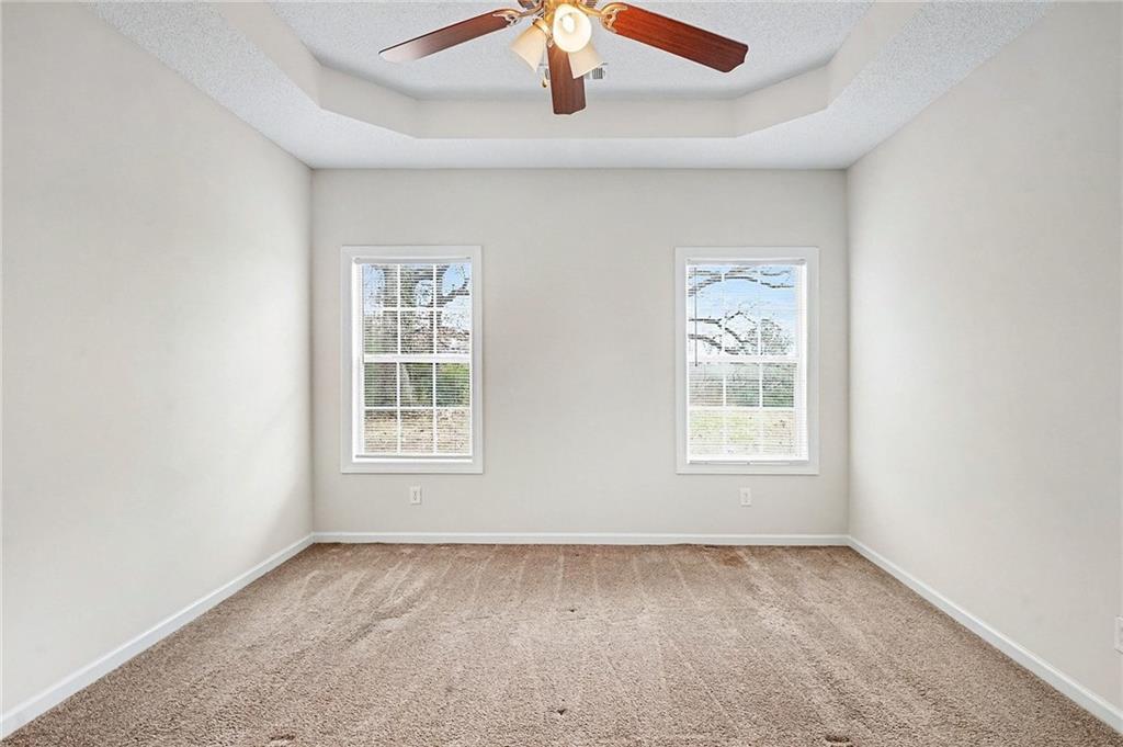 1558 Kilgore Road Griffin, GA 30223 - Photo 16 of 32 an empty room with a window and a ceiling fan