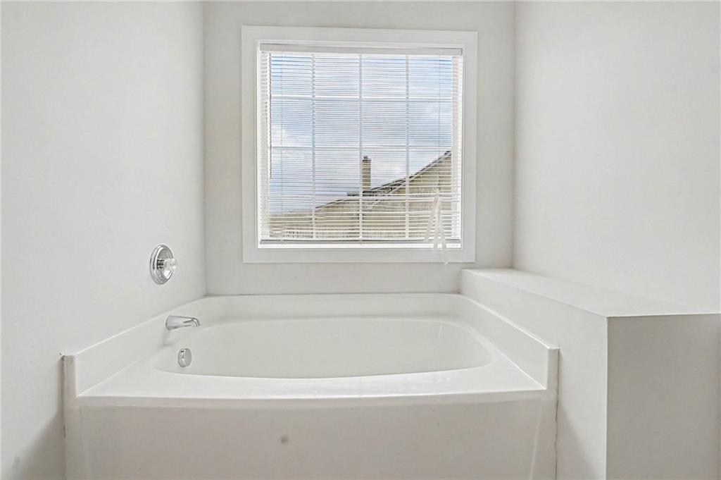 1558 Kilgore Road Griffin, GA 30223 - Photo 29 of 32 a white bath tub sitting next to a window