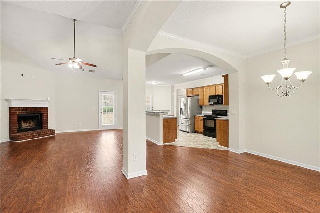 1558 Kilgore Road Griffin, GA 30223 - Photo 5 of 32 a view of a kitchen and an empty room with wooden floor