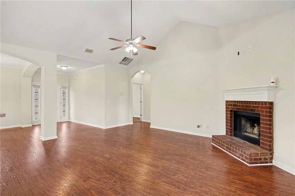 1558 Kilgore Road Griffin, GA 30223 - Photo 7 of 32 a view of an empty room with wooden floor and a fireplace