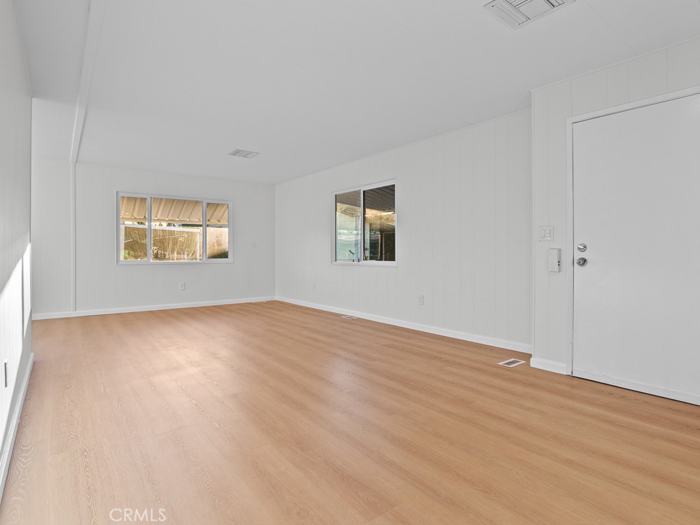 8301 Mission Gorge Road, Unit 172 Santee, CA 92071 - Photo 11 of 30 a view of an empty room with wooden floor and a window