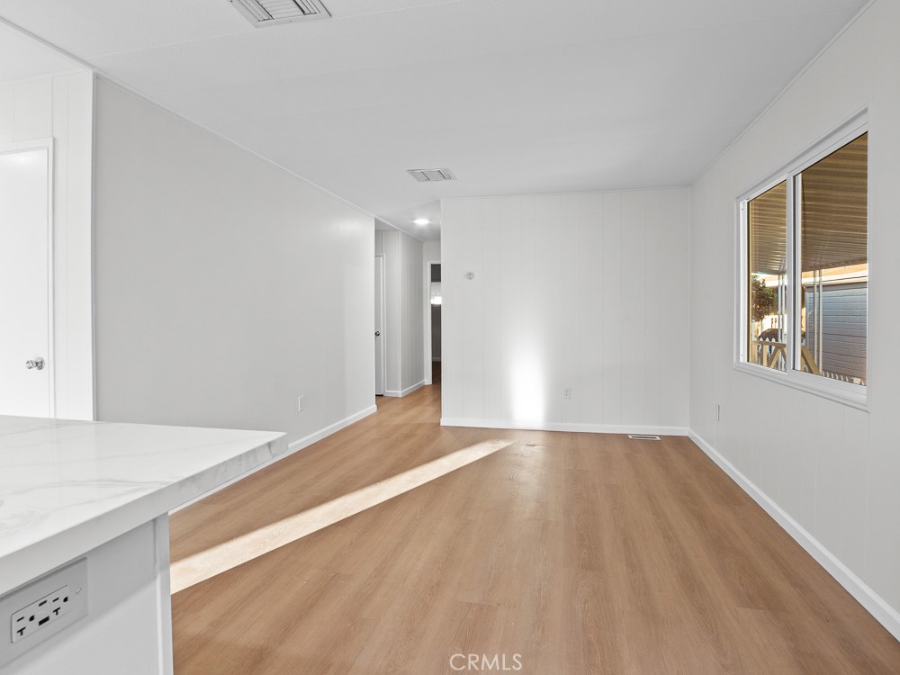 8301 Mission Gorge Road, Unit 172 Santee, CA 92071 - Photo 12 of 30 a view of an empty room with window and wooden floor