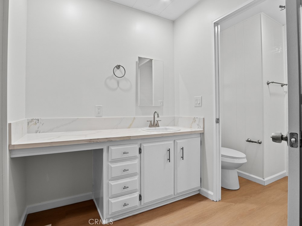 8301 Mission Gorge Road, Unit 172 Santee, CA 92071 - Photo 20 of 30 a spacious bathroom with a double vanity sink a toilet and a mirror