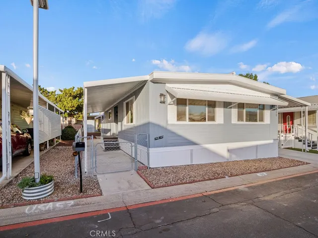 a front view of a house with garden and plants