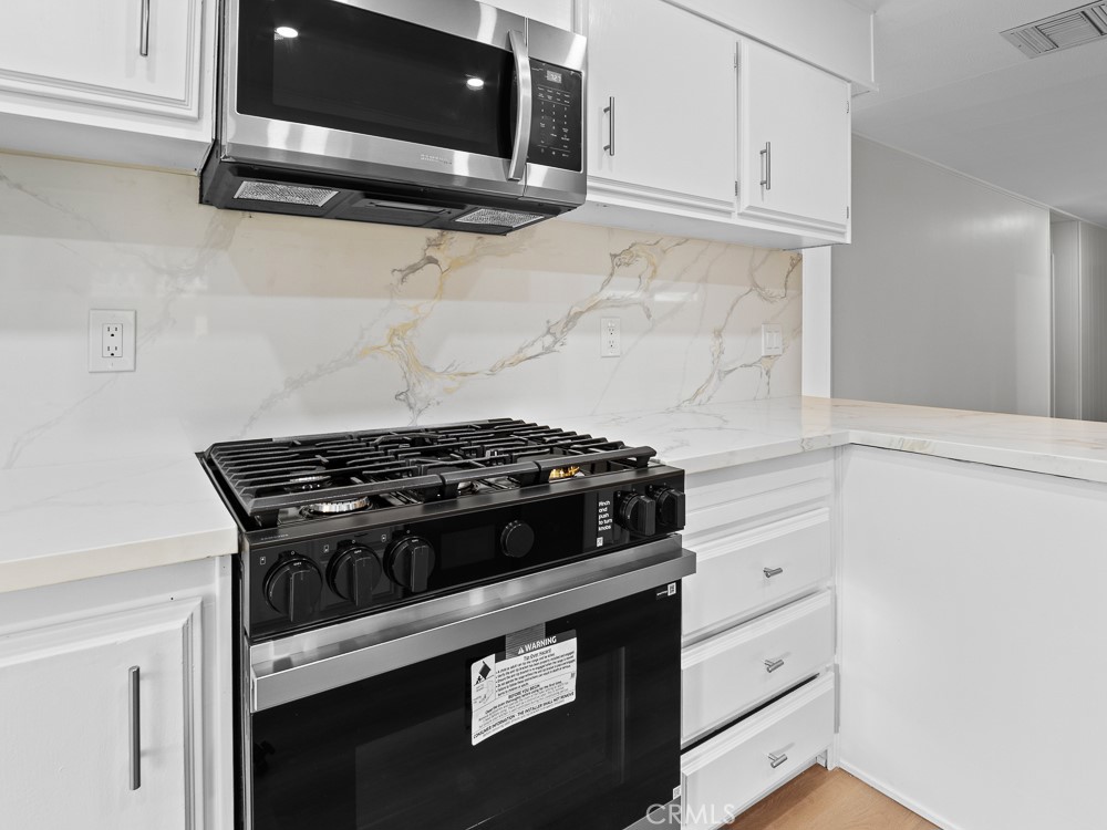 8301 Mission Gorge Road, Unit 172 Santee, CA 92071 - Photo 5 of 30 a stove top oven sitting inside of a kitchen