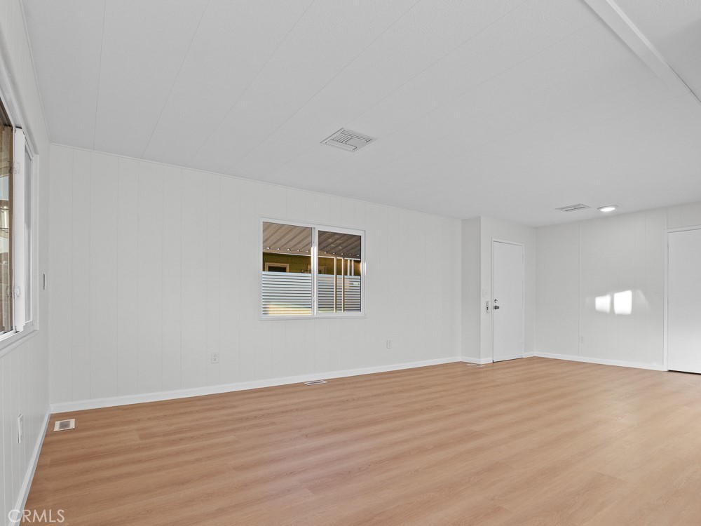 8301 Mission Gorge Road, Unit 172 Santee, CA 92071 - Photo 8 of 30 a view of empty room with wooden floor and fan