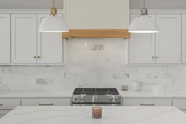 a kitchen with granite countertop a sink stove and cabinets