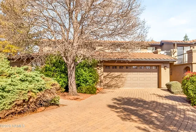 a view of a house with a yard and pathway