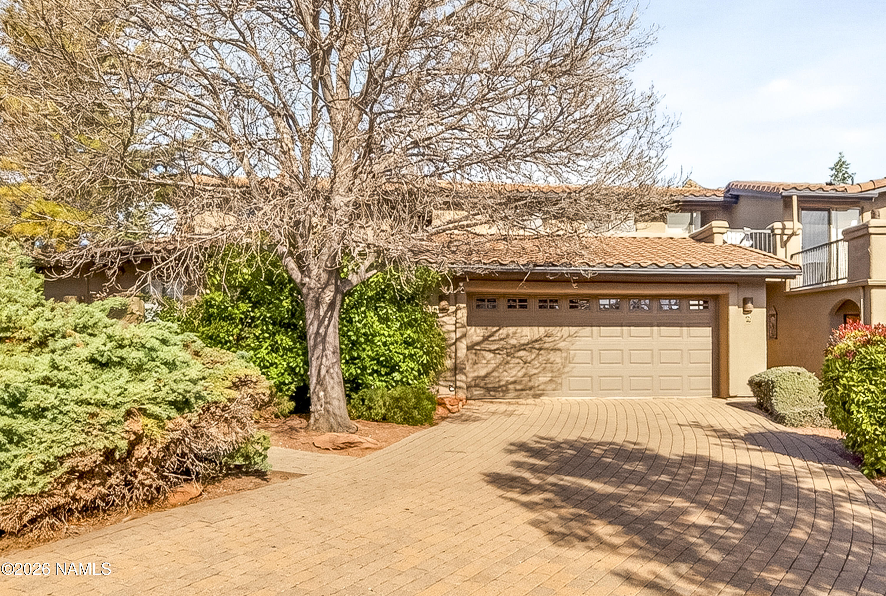 a view of a house with a yard and pathway