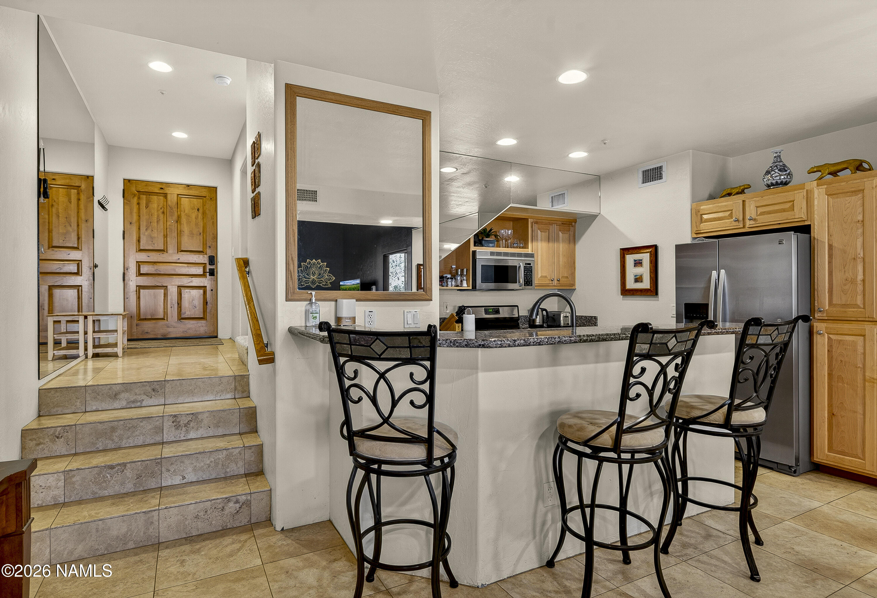 318 Capital Butte Road, Unit 2 Sedona, AZ 86336 - Photo 12 of 30 a kitchen with stainless steel appliances kitchen island granite countertop a table and chairs
