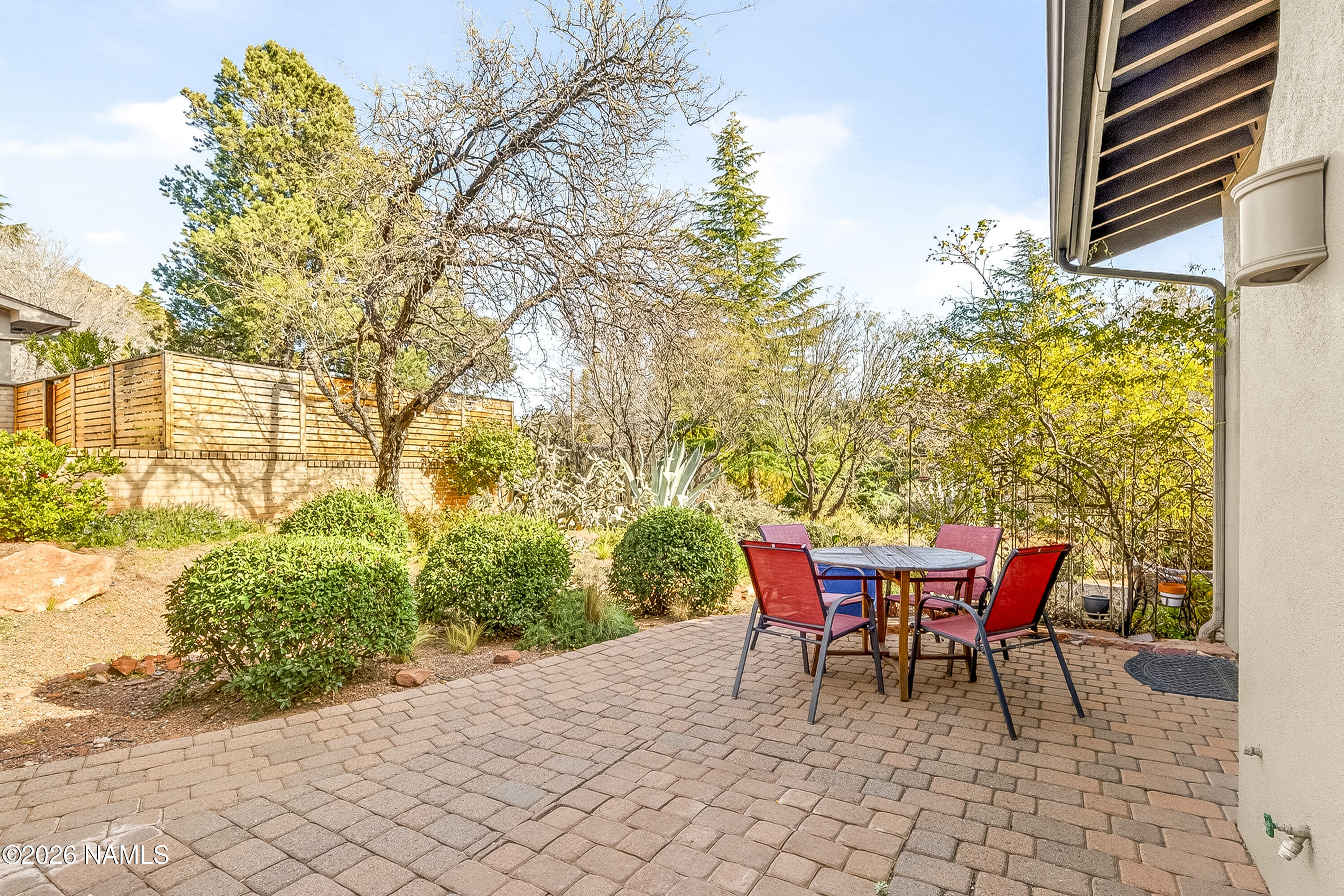 318 Capital Butte Road, Unit 2 Sedona, AZ 86336 - Photo 13 of 30 a patio with table and chairs and potted plants