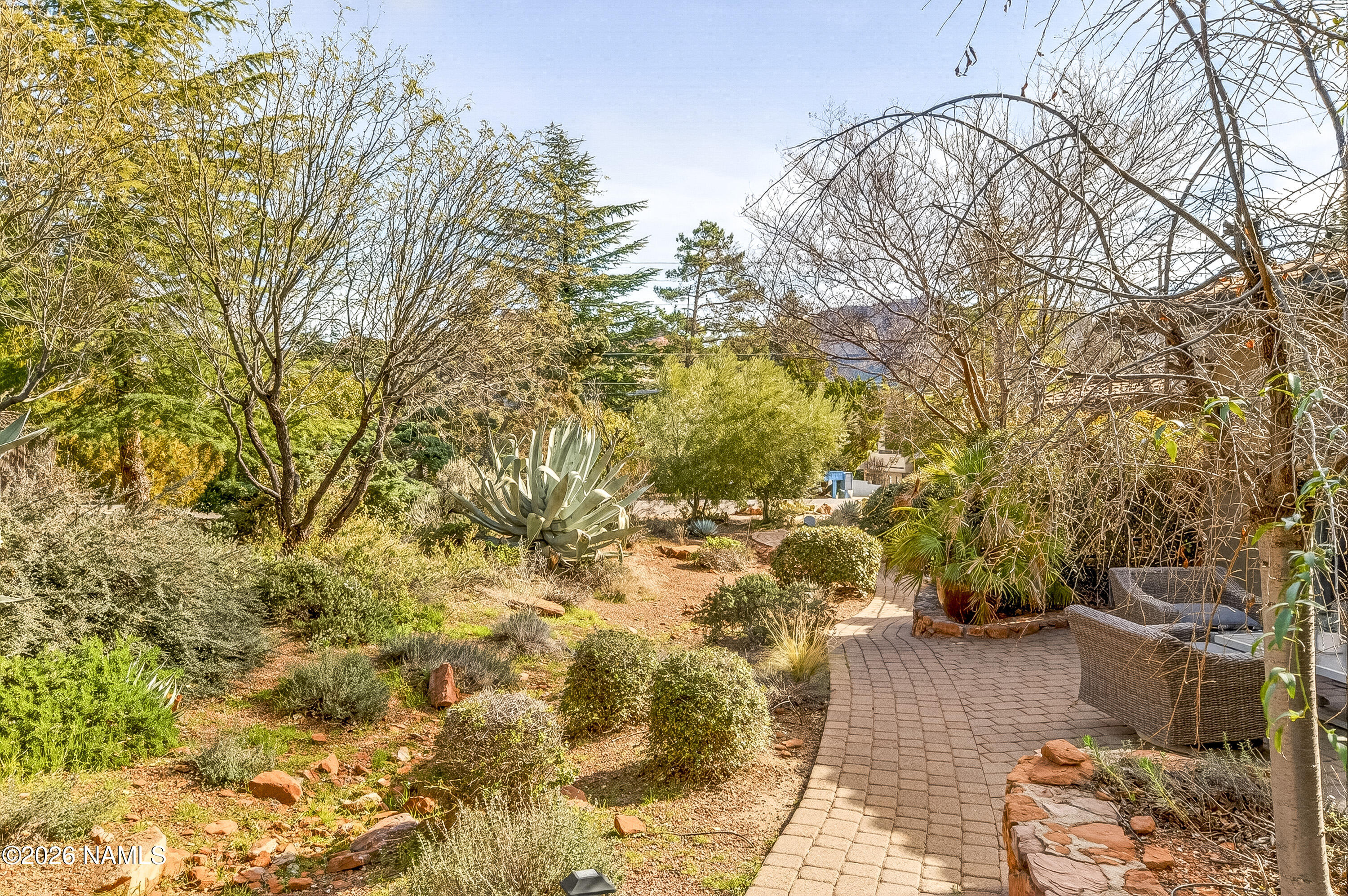 318 Capital Butte Road, Unit 2 Sedona, AZ 86336 - Photo 14 of 30 a view of a yard with plants and large trees