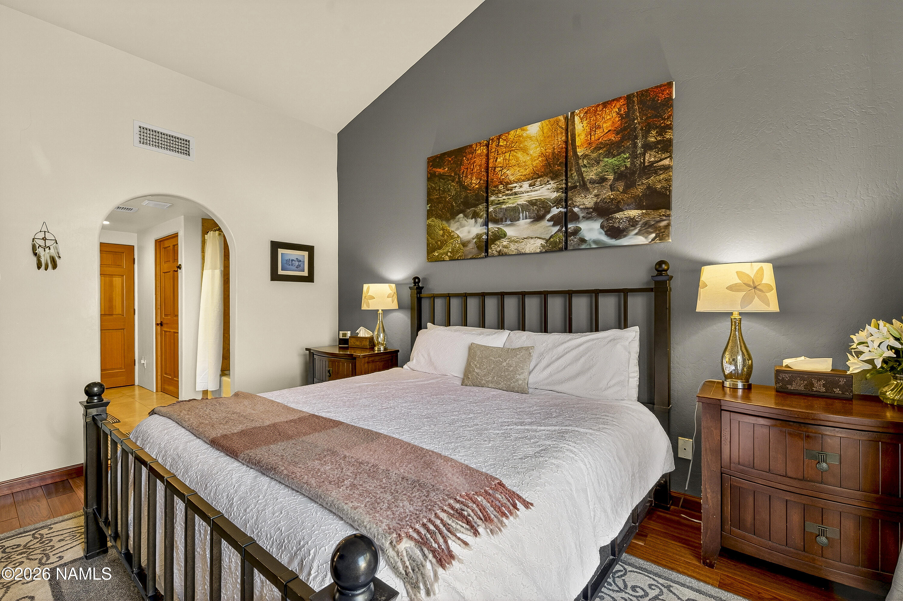 318 Capital Butte Road, Unit 2 Sedona, AZ 86336 - Photo 18 of 30 a bedroom with a bed and wooden floor