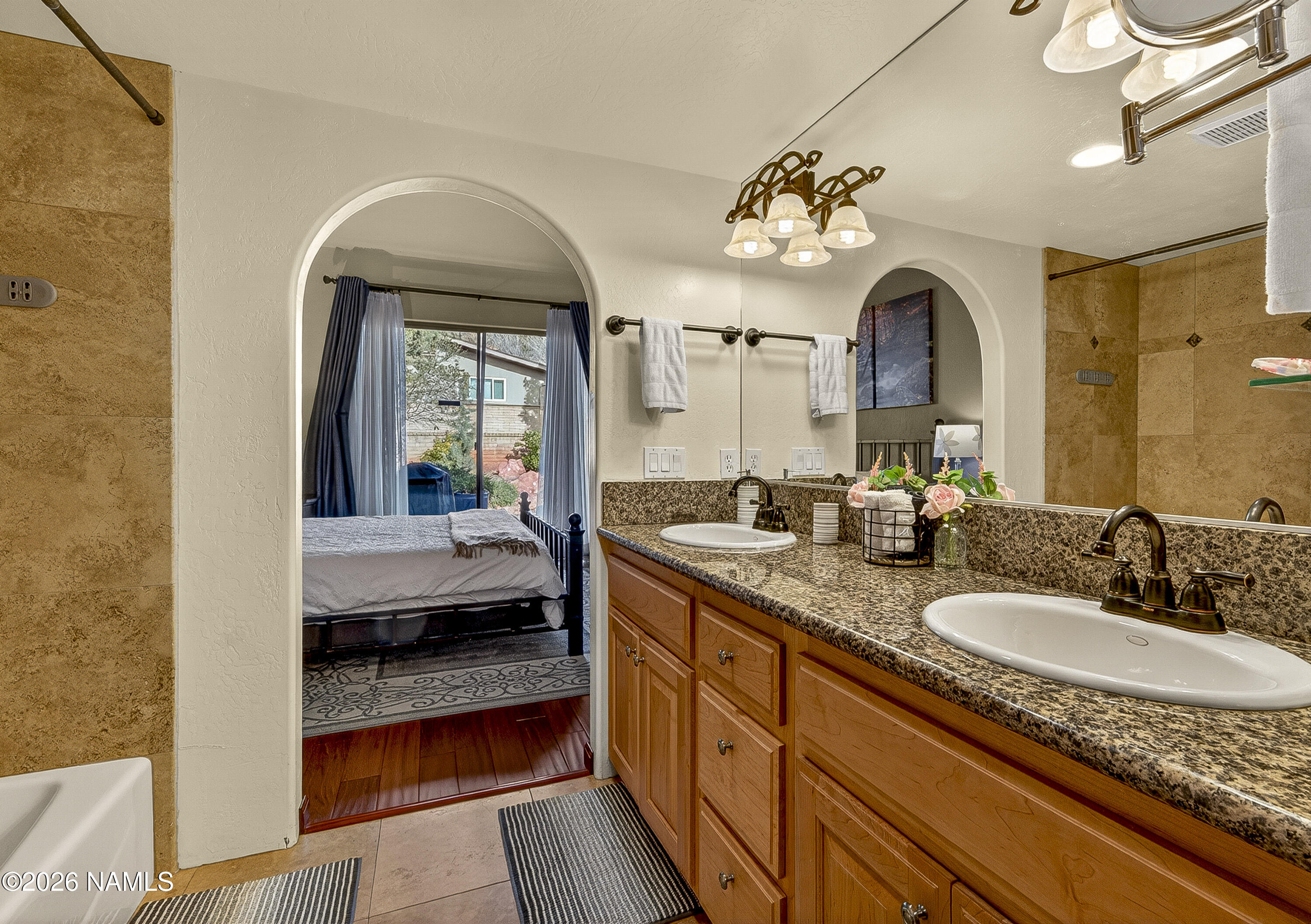 318 Capital Butte Road, Unit 2 Sedona, AZ 86336 - Photo 20 of 30 a en suite bathroom with a granite countertop sink mirror and vanity