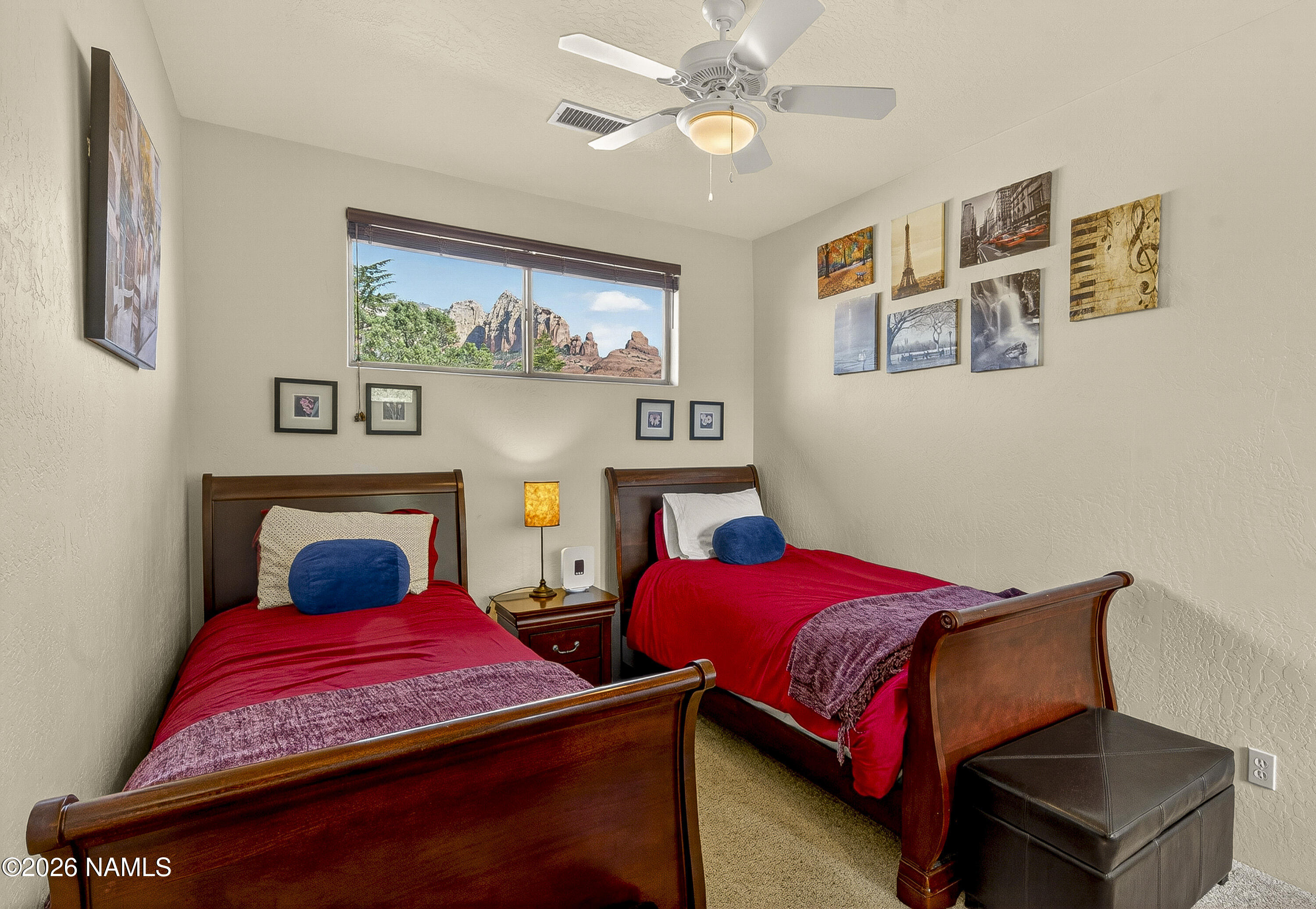 318 Capital Butte Road, Unit 2 Sedona, AZ 86336 - Photo 21 of 30 a bedroom with a bed a couch and paintings on the wall