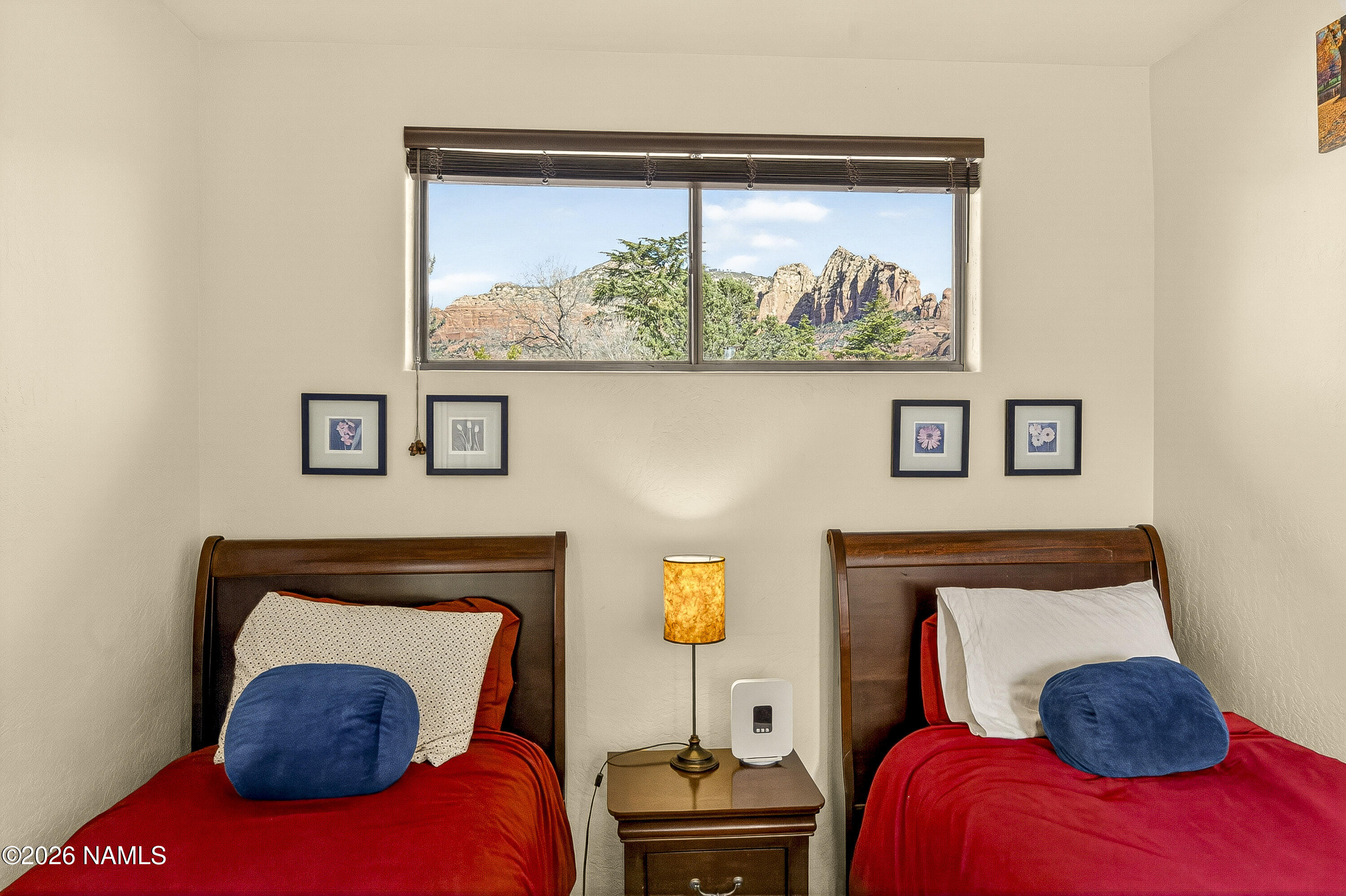 318 Capital Butte Road, Unit 2 Sedona, AZ 86336 - Photo 22 of 30 a bedroom with a bed and painting on the wall