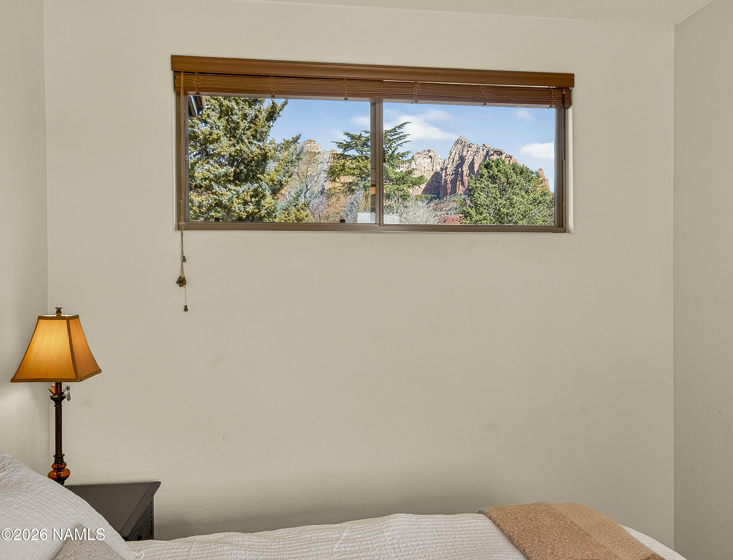 318 Capital Butte Road, Unit 2 Sedona, AZ 86336 - Photo 28 of 30 a bedroom with a bed and a painting on the wall