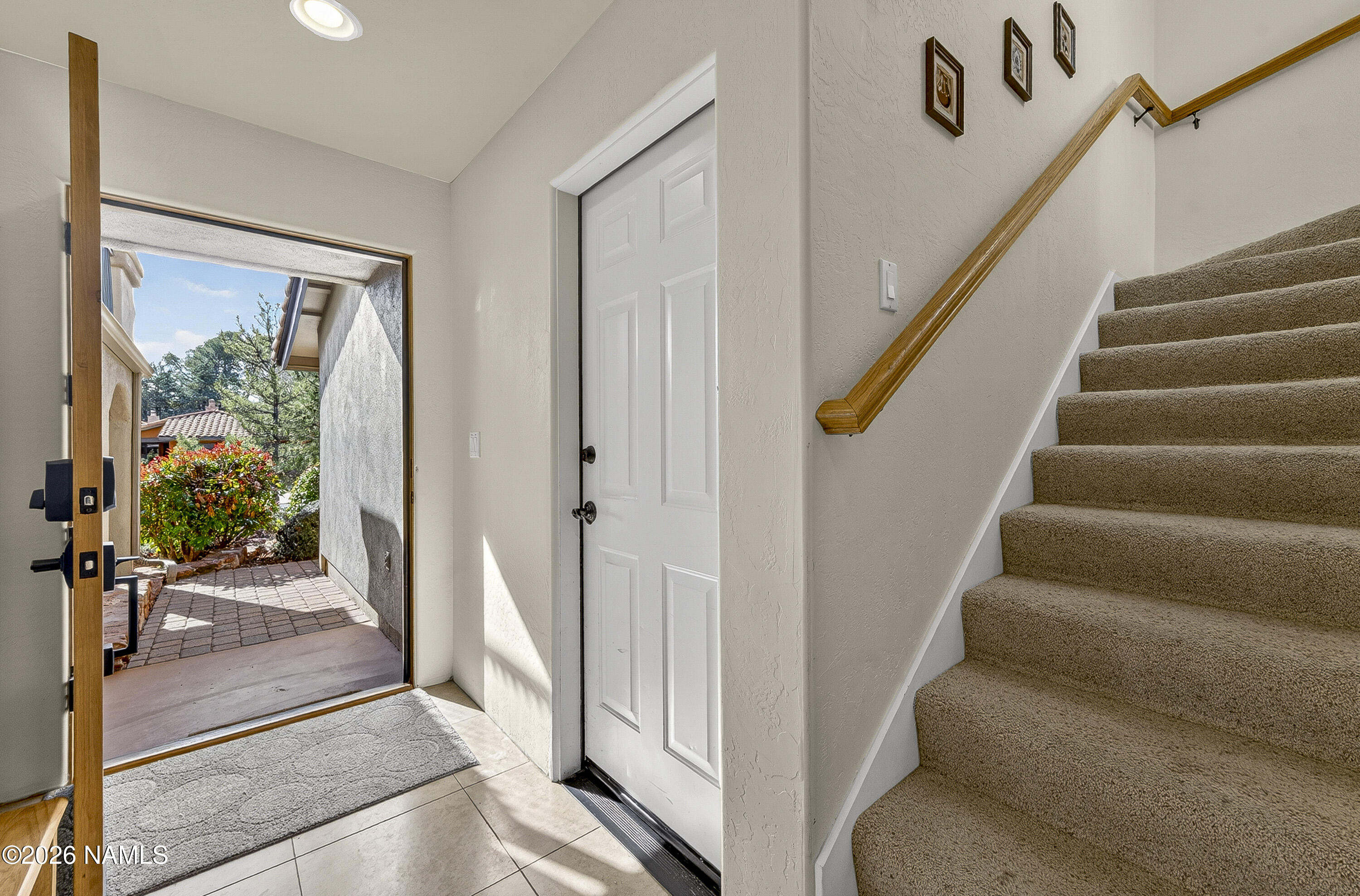 318 Capital Butte Road, Unit 2 Sedona, AZ 86336 - Photo 5 of 30 a view of staircase with lots of frames on wall and a large window