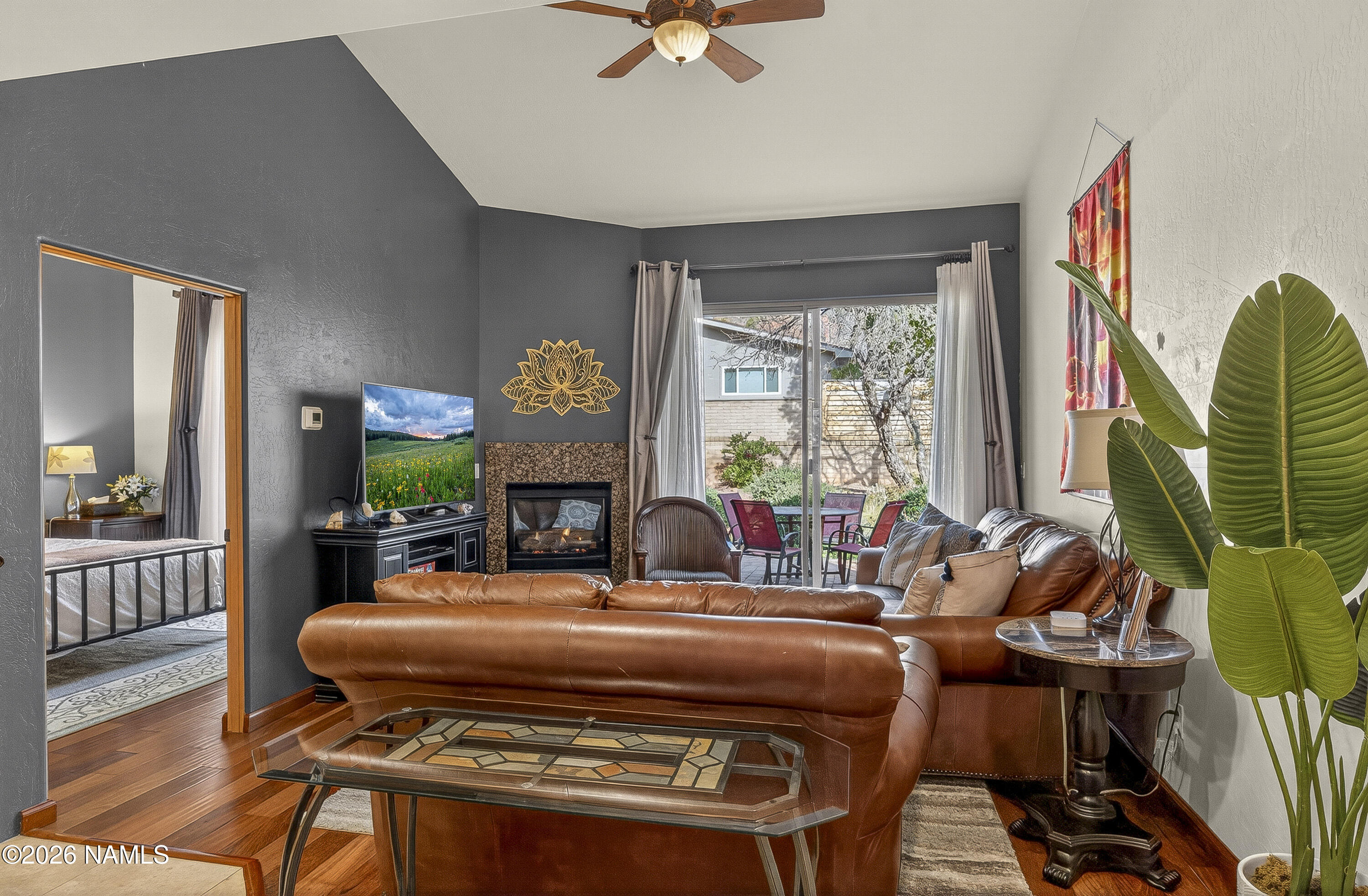318 Capital Butte Road, Unit 2 Sedona, AZ 86336 - Photo 6 of 30 a living room with furniture a fireplace and a large window