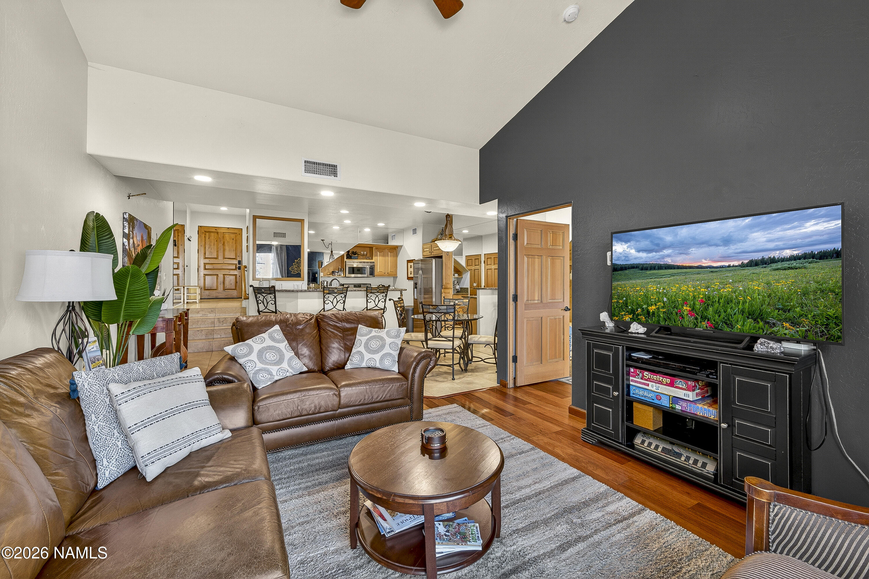 318 Capital Butte Road, Unit 2 Sedona, AZ 86336 - Photo 9 of 30 a living room with furniture a flat screen tv and a fireplace