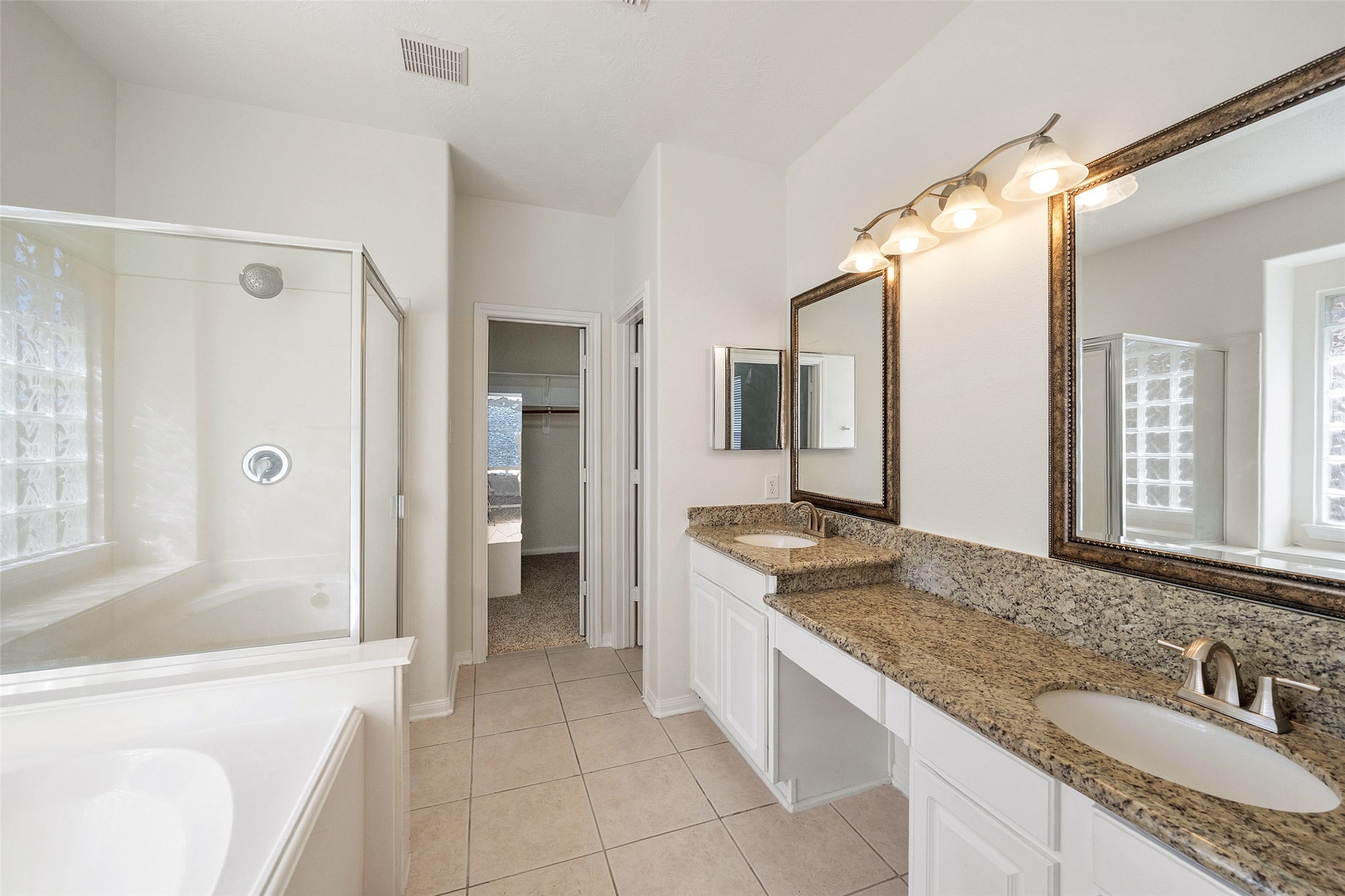 14213 Stone Bluff Lane Rosharon, TX 77583 - Photo 27 of 44 a bathroom with a granite countertop sink and a mirror a bathtub