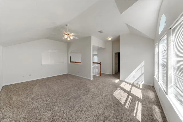 a living room with furniture a flat screen tv and a window