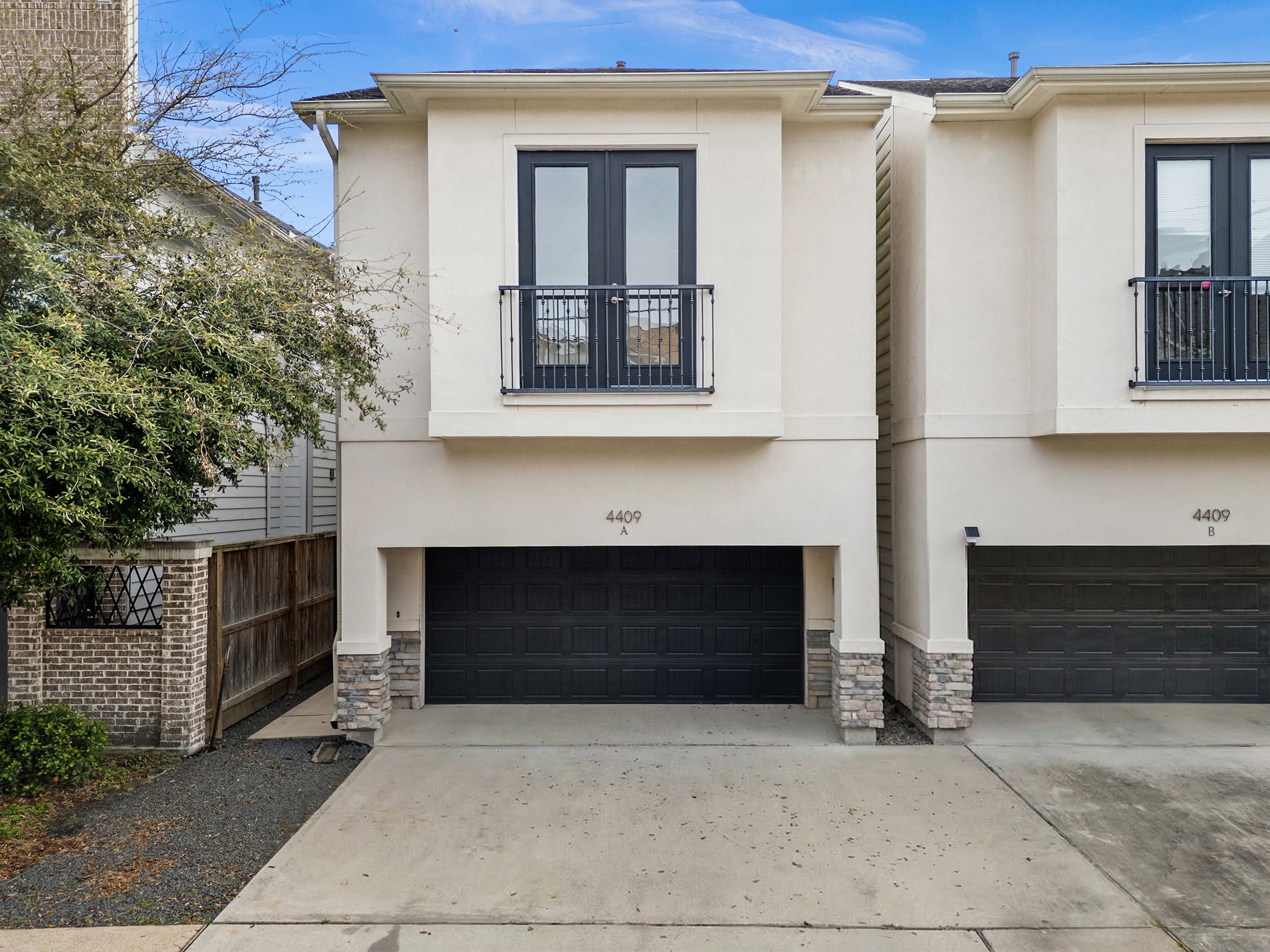 Contemporary 3-bedroom, 2.5-bath Rice Military home featuring a clean two-story exterior, 2-car garage, private driveway, and a second-floor balcony accessed through double glass doors.