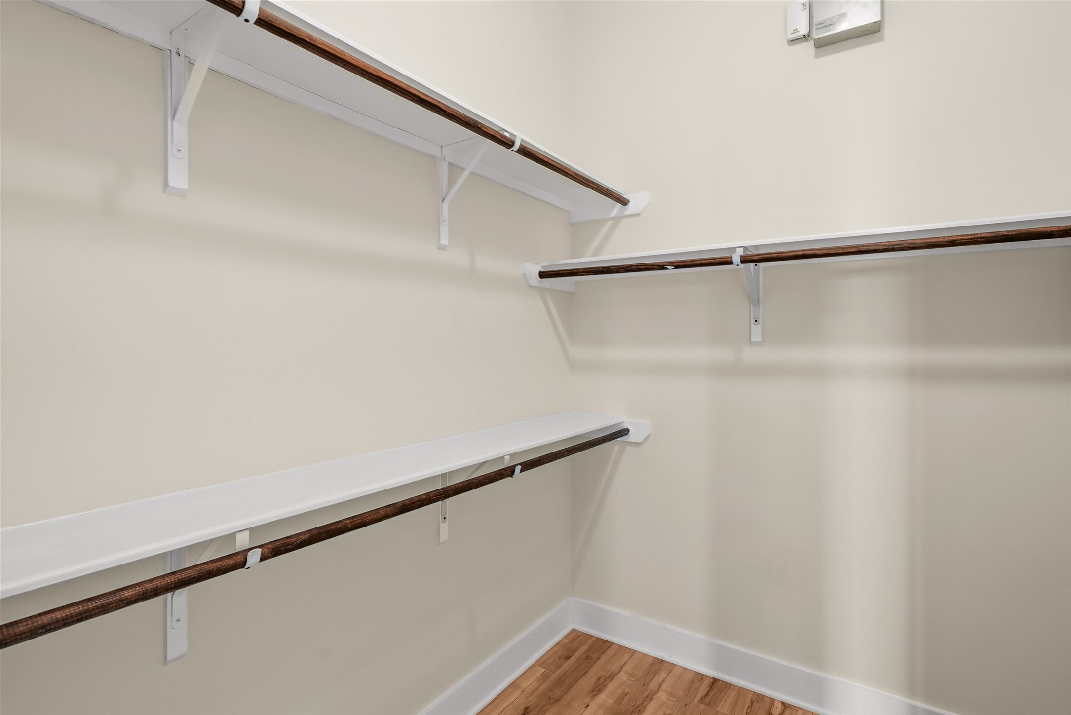 4409 Schuler Street, Unit A Houston, TX 77007 - Photo 18 of 33 Walk-in closet is equipped with multiple built-in wooden hanging rods and overhead shelving.