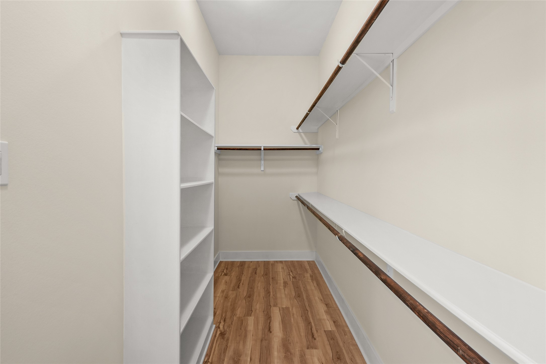 4409 Schuler Street, Unit A Houston, TX 77007 - Photo 19 of 33 Primary closet features an integrated white shelving unit and long hanging rods.