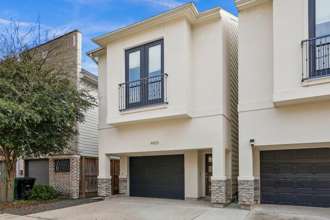 4409 Schuler Street, Unit A Houston, TX 77007 - Photo 2 of 33 Angled view of the front facade highlighting the garage access and front landscaping.