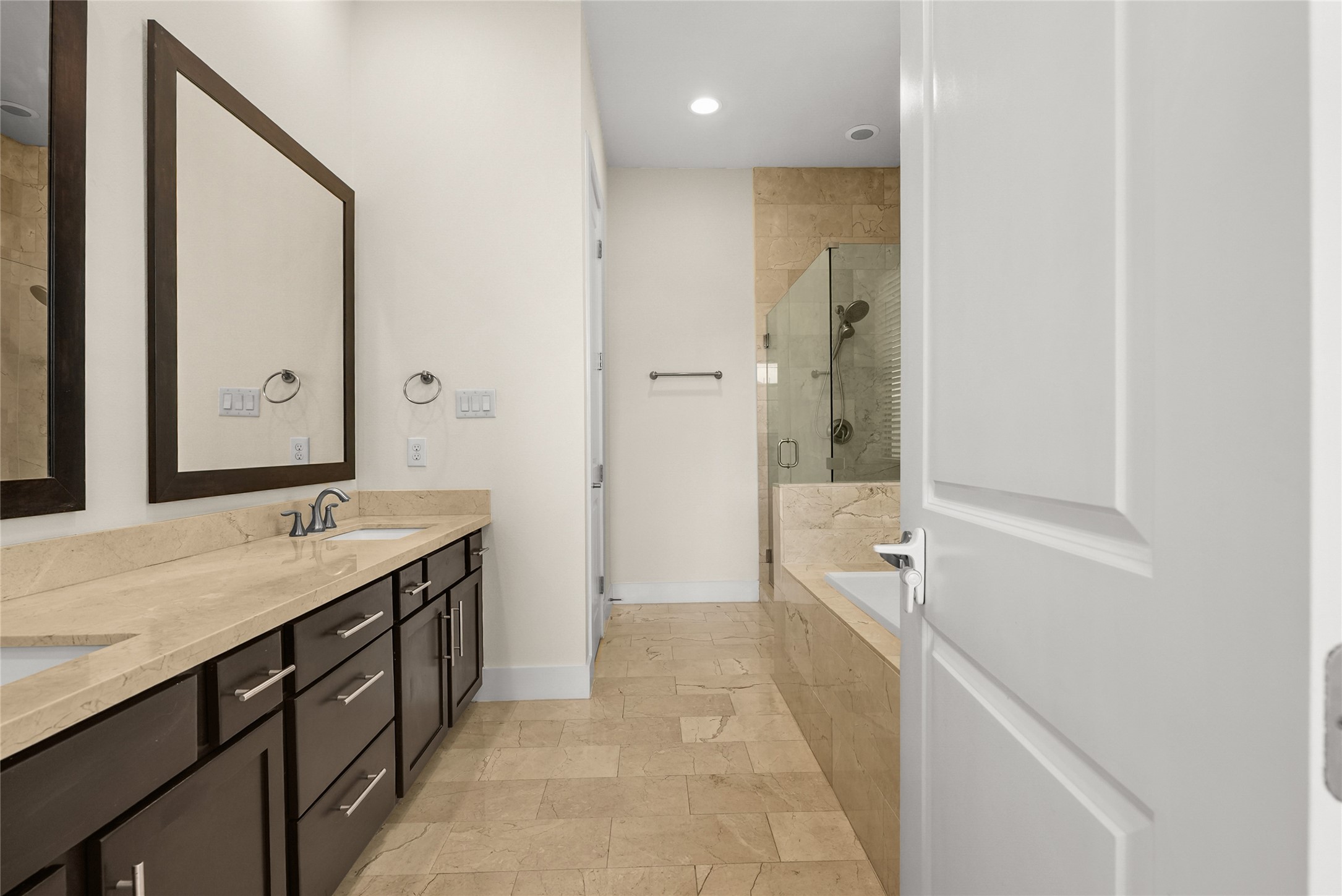 4409 Schuler Street, Unit A Houston, TX 77007 - Photo 22 of 33 Primary bathroom features a double vanity with dark cabinetry and a separate glass-enclosed shower.