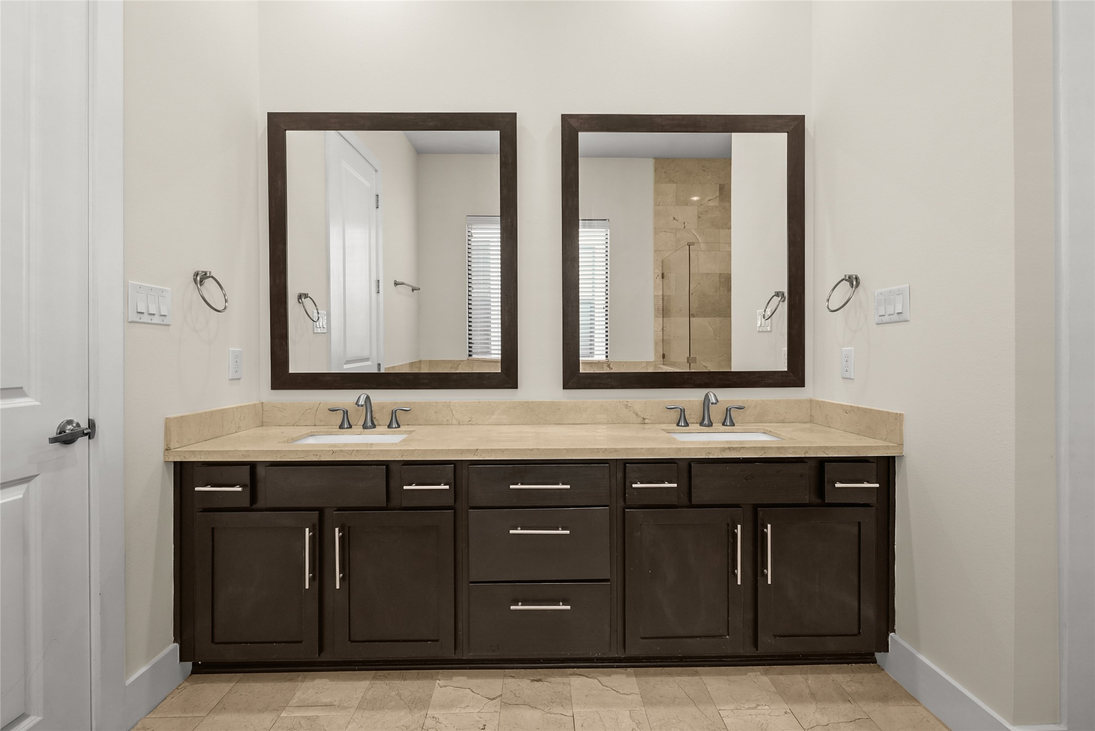 4409 Schuler Street, Unit A Houston, TX 77007 - Photo 23 of 33 Dual-sink vanity includes stone countertops, framed mirrors, and under-sink cabinet storage.