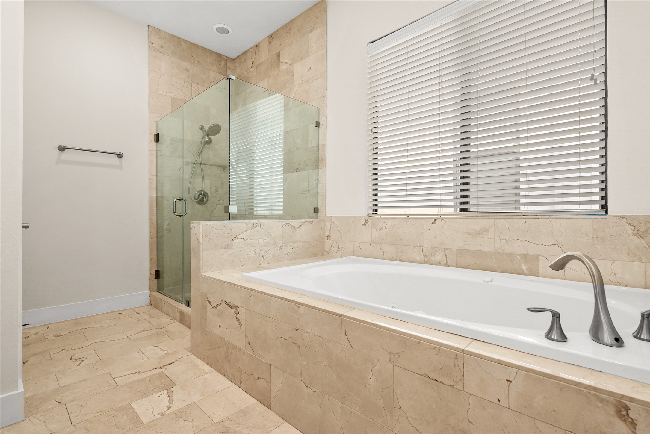 4409 Schuler Street, Unit A Houston, TX 77007 - Photo 24 of 33 En-suite bathroom contains a large soaking tub with tile surround and a walk-in shower with a glass partition.