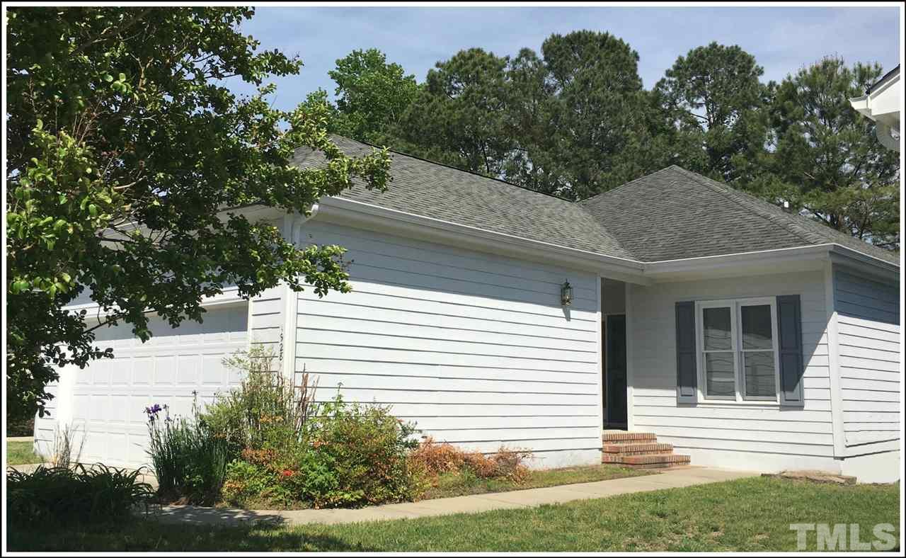 a view of house with backyard and garden