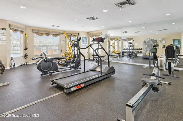 a kitchen with stainless steel appliances granite countertop a refrigerator a stove a sink and a microwave