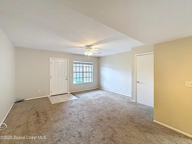 an empty room with windows and closet