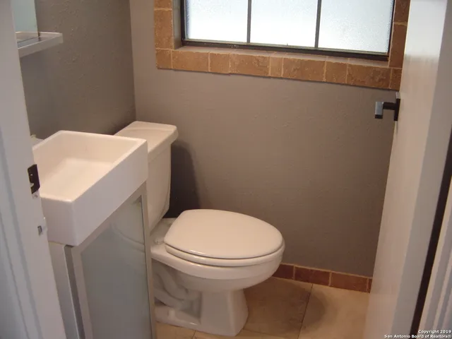 a bathroom with a toilet and a sink