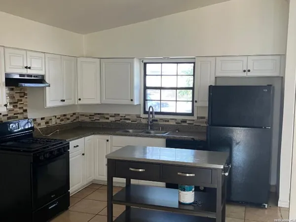 a kitchen with a sink appliances and cabinets