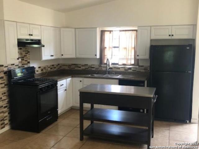442 Sharon Drive San Antonio, TX 78216 - Photo 6 of 15 a kitchen with kitchen island a counter space and a refrigerator