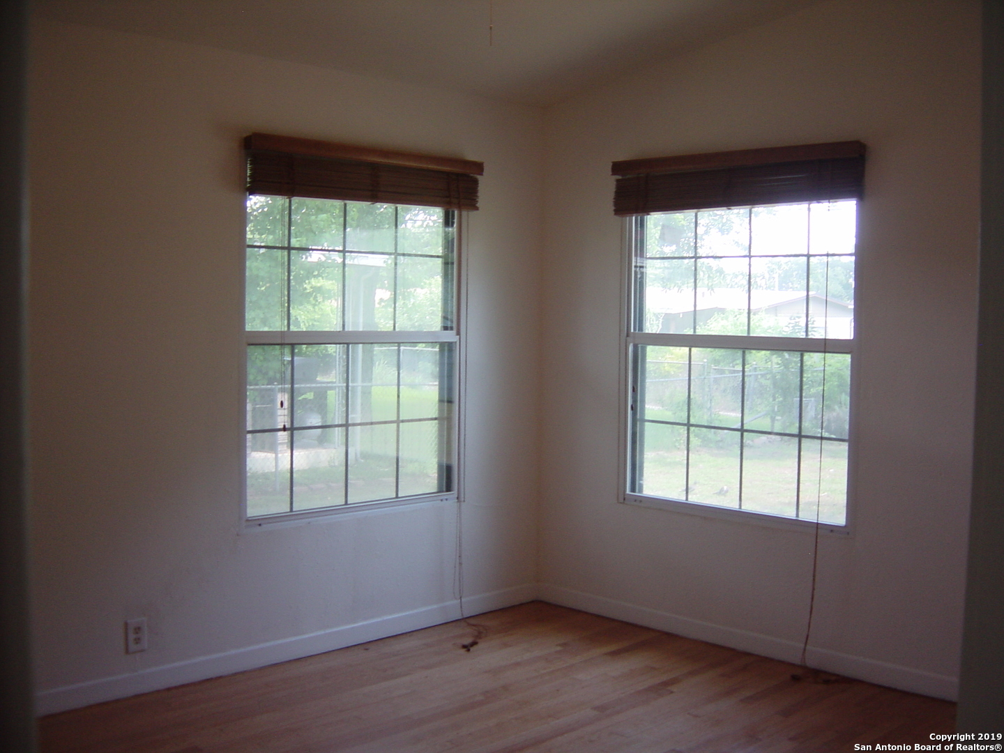 442 Sharon Drive San Antonio, TX 78216 - Photo 9 of 15 an empty room with wooden floor and windows