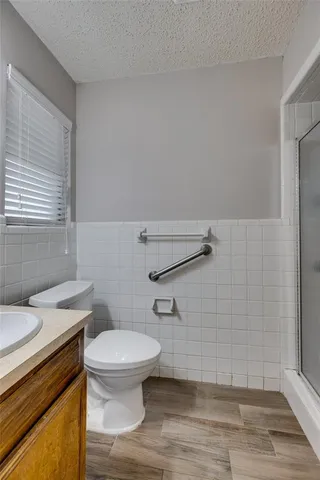 a bathroom with a toilet and a shower
