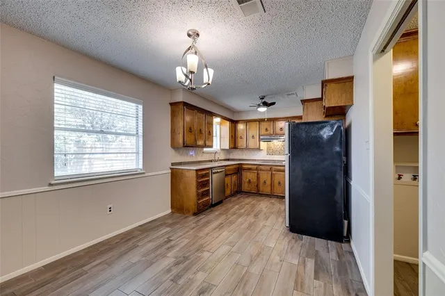 a kitchen with a refrigerator and a sink